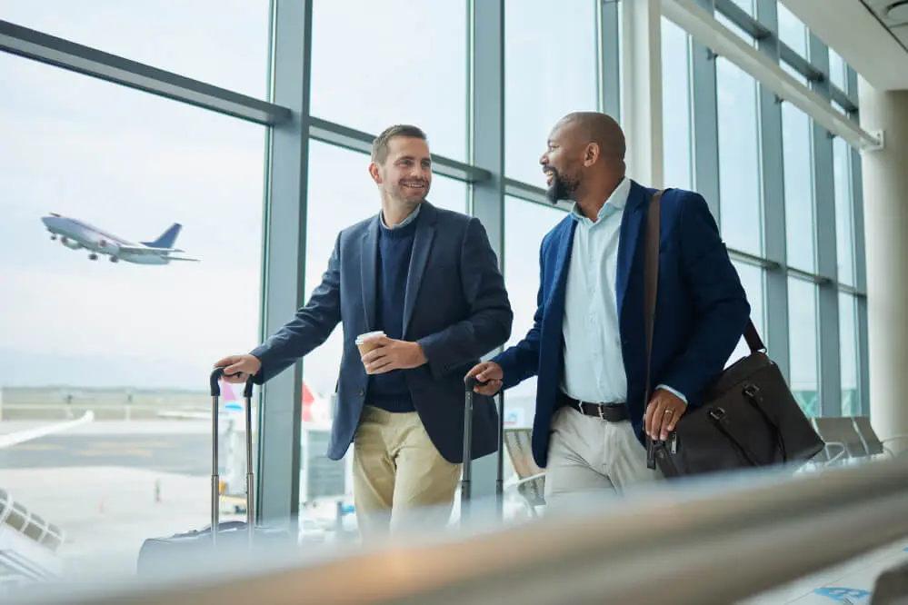 Two men at airport terminal window
