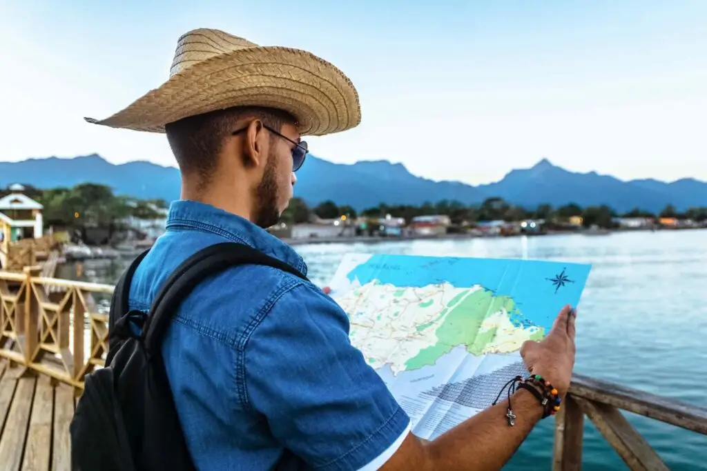 male traveler wearing a hat dark glasses and a ba scaled 1