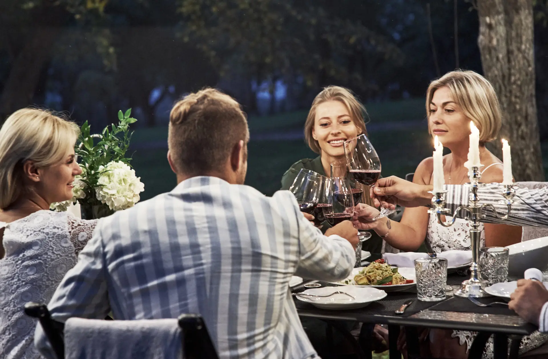 Friends enjoying dinner and drinks together.