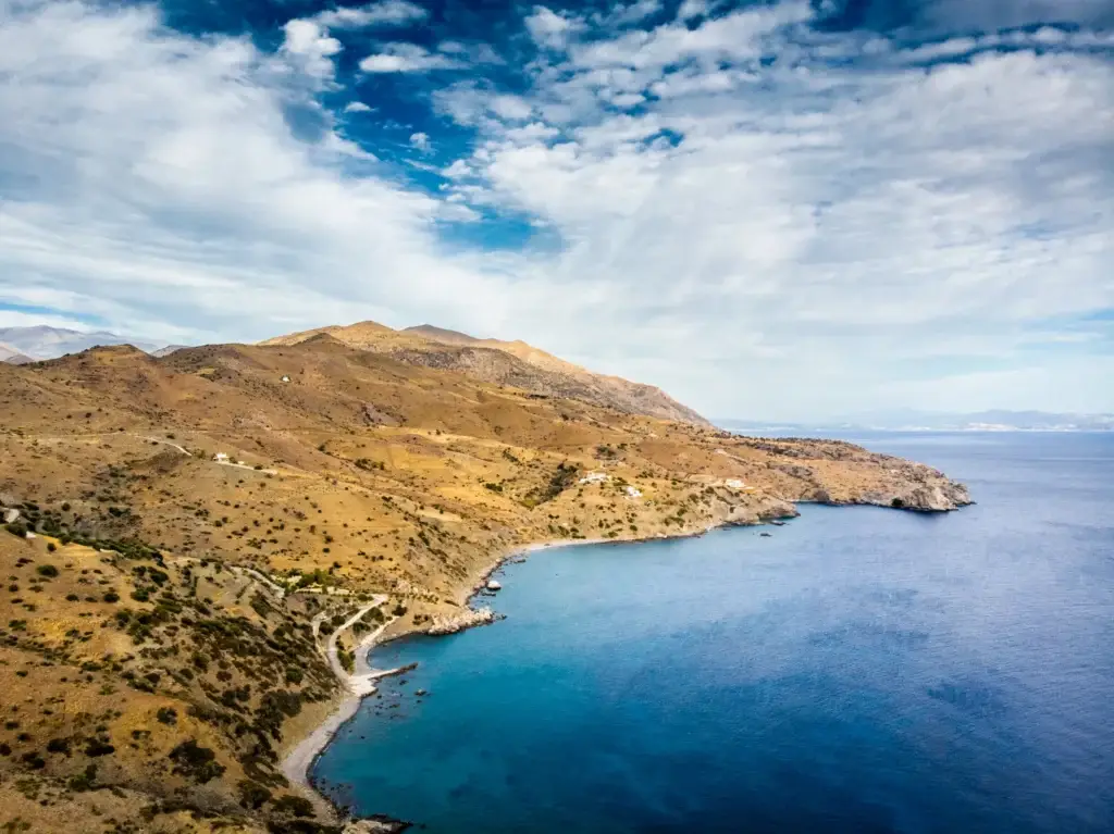 Rocky Cretan coastline with deep blue sea and mountains