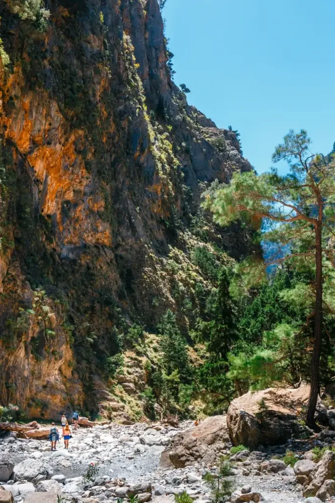 Hikers on a rocky path through Samaria Gorge in Crete