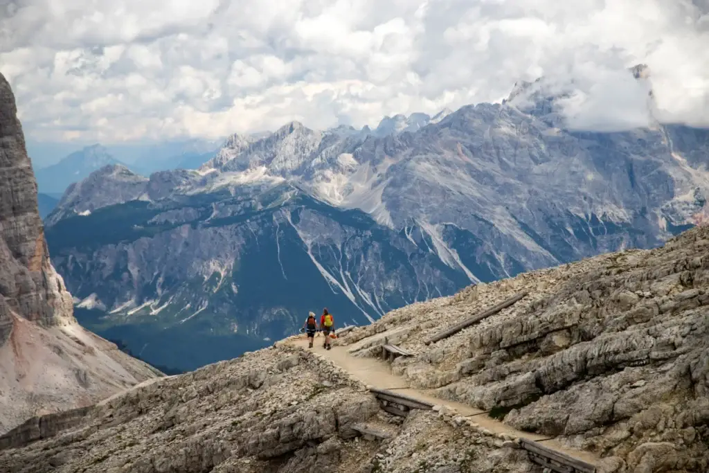 Couple enjoys the view from Lagazuoi mountain over the italian Dolomites.