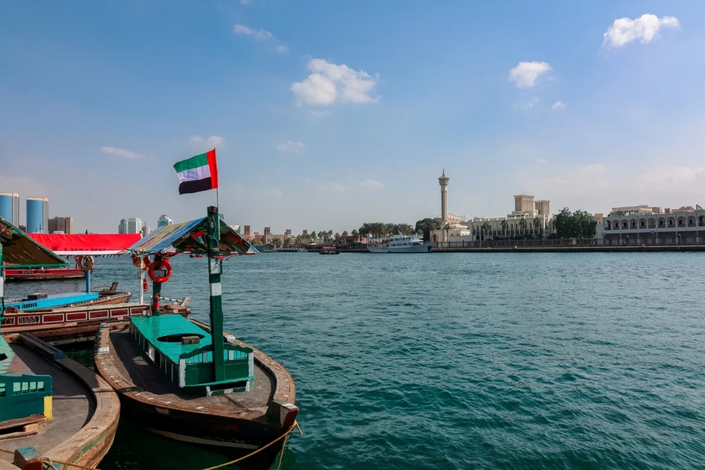 Traditional abras on Dubai Creek with the historic waterfront beyond