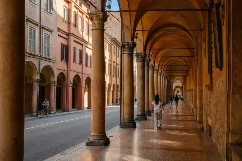 Long covered portico with repeated arches in central Bologna
