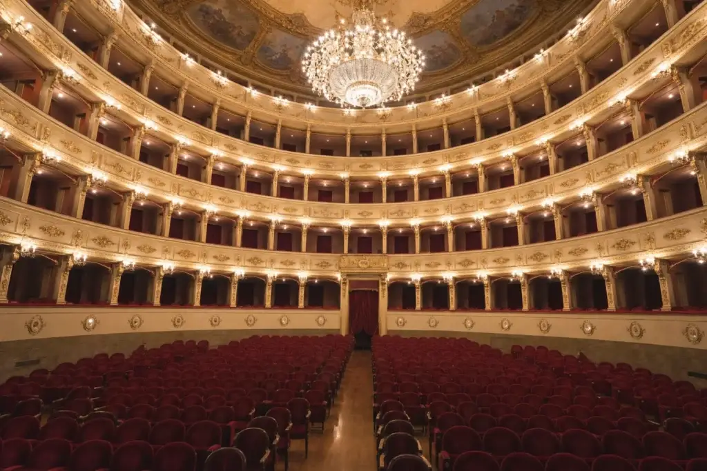 Historic opera-house auditorium with four tiers of boxes and a central chandelier
