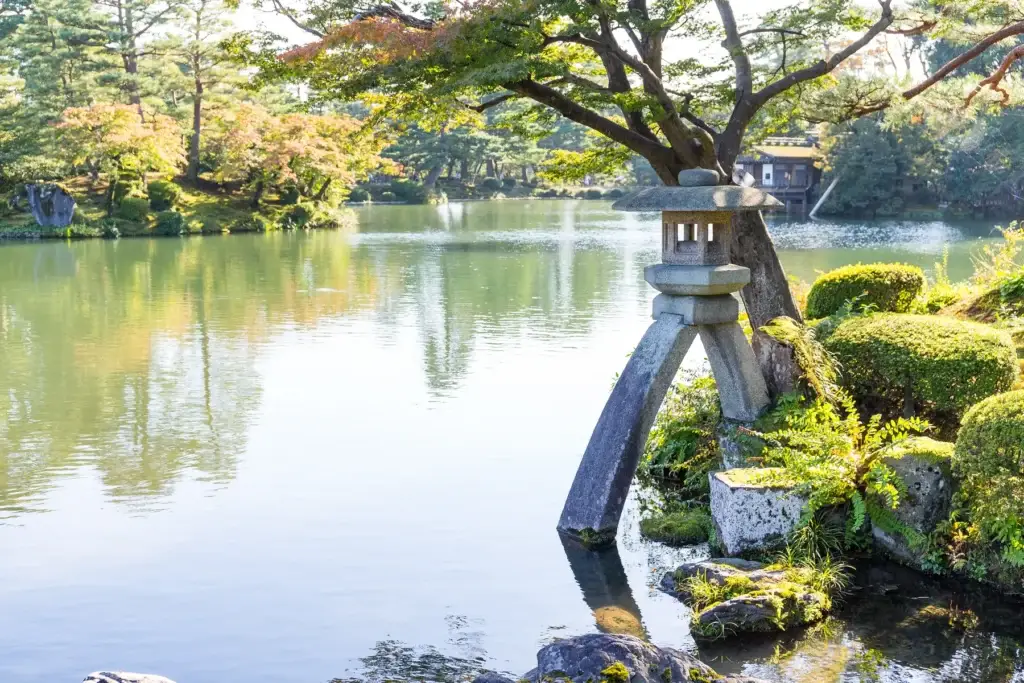 Stone lantern beside a pond in a Kanazawa garden