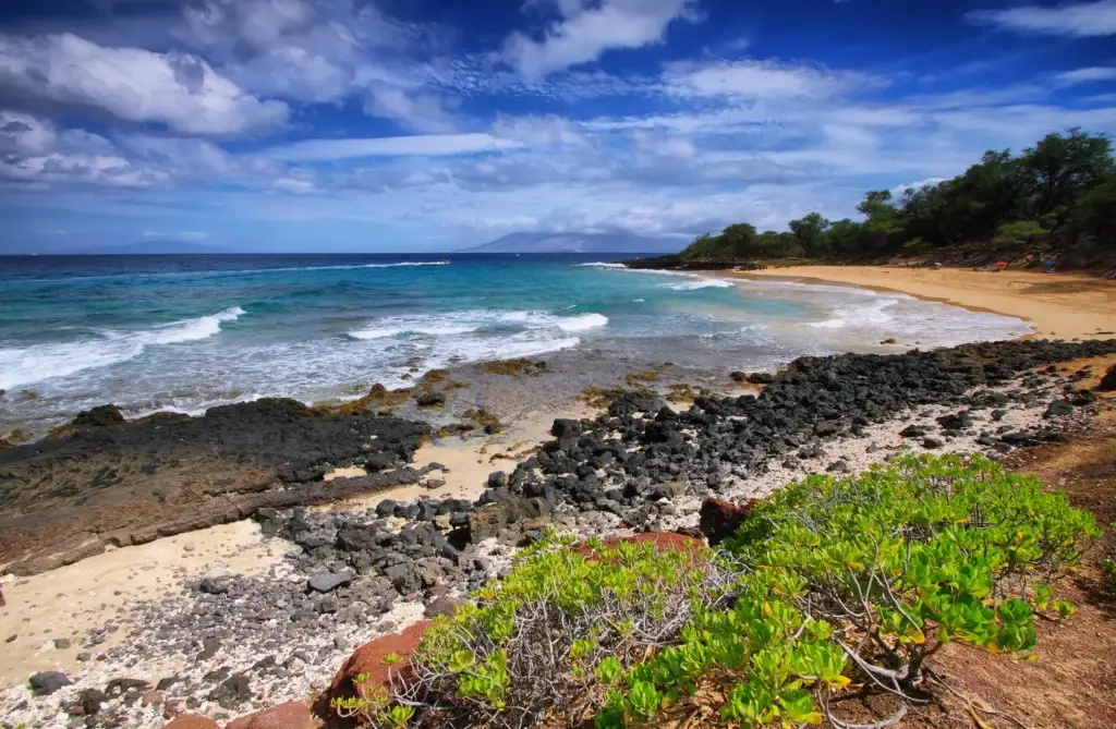 Rocky shoreline and blue water at Makena on Maui