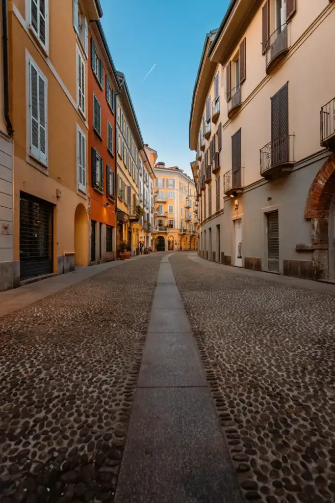 Quiet cobblestone street in Milan's Brera district at sunset