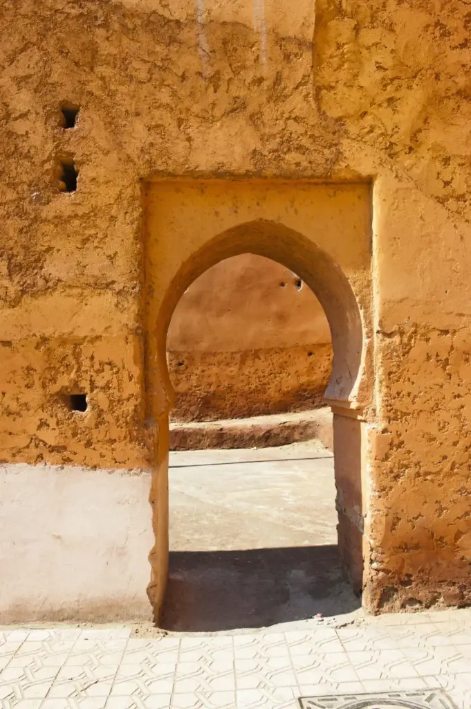 Arched doorway set into the ochre walls of Marrakech’s old Medina