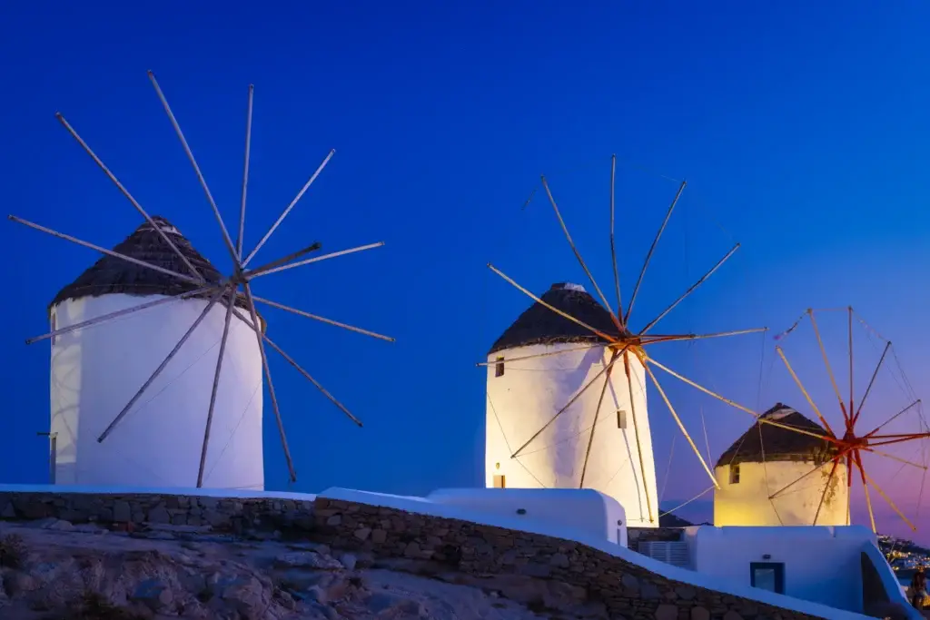 Traditional windmills above Mykonos at sunset