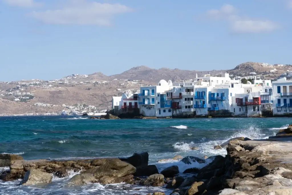 Blue Aegean water and whitewashed buildings along Little Venice in Mykonos