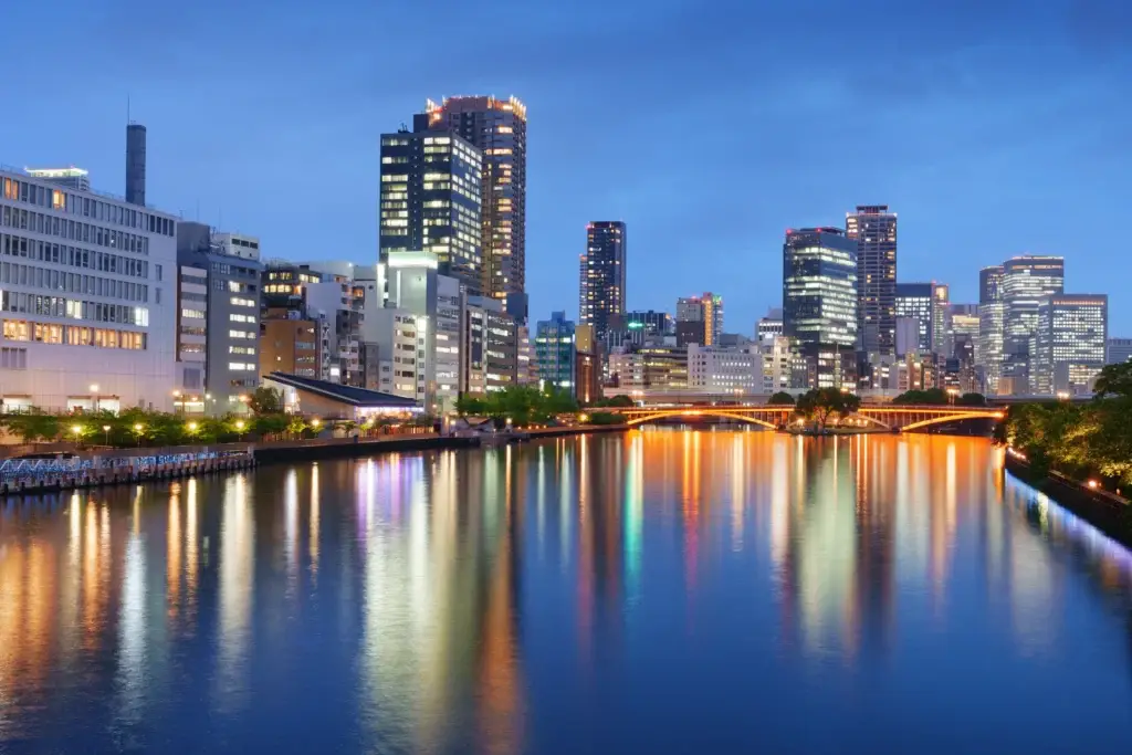 Osaka skyline reflected in the river at blue hour