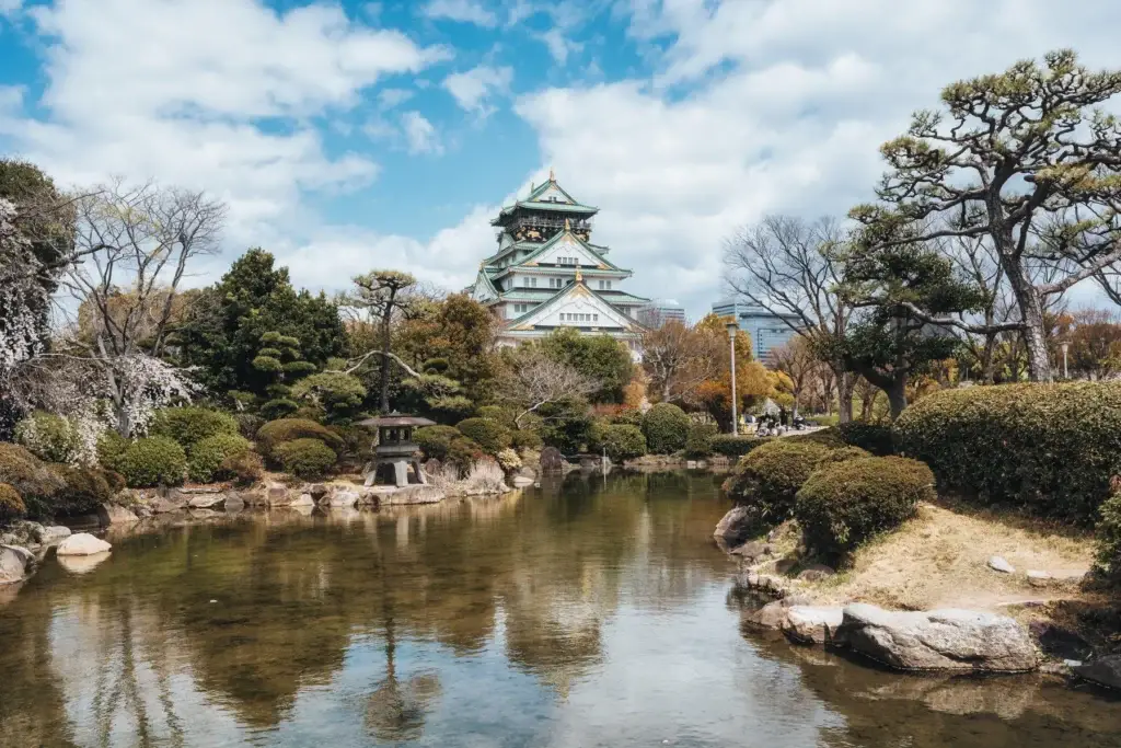 Osaka Castle seen across a garden pond
