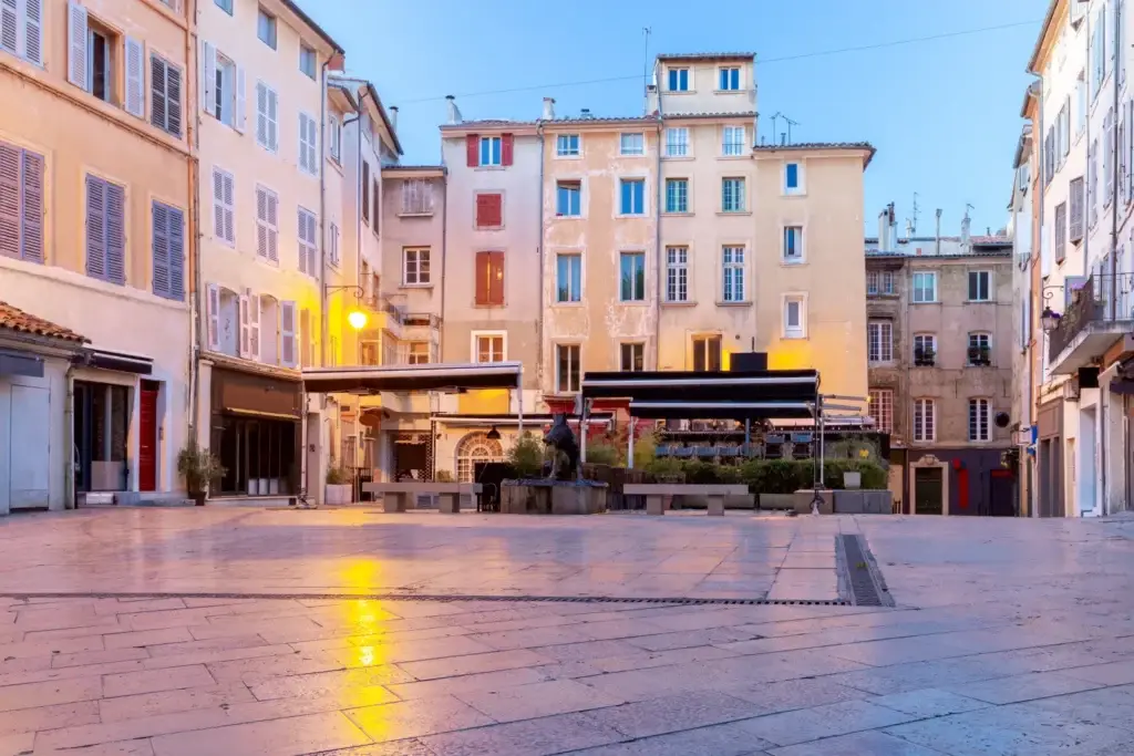 Quiet early-morning square lined with warm-toned buildings in Aix-en-Provence
