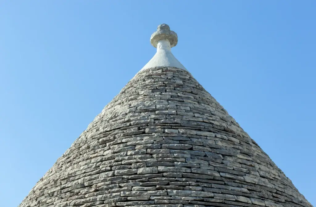 Close view of a traditional trulli stone roof and pinnacolo in Alberobello, Puglia
