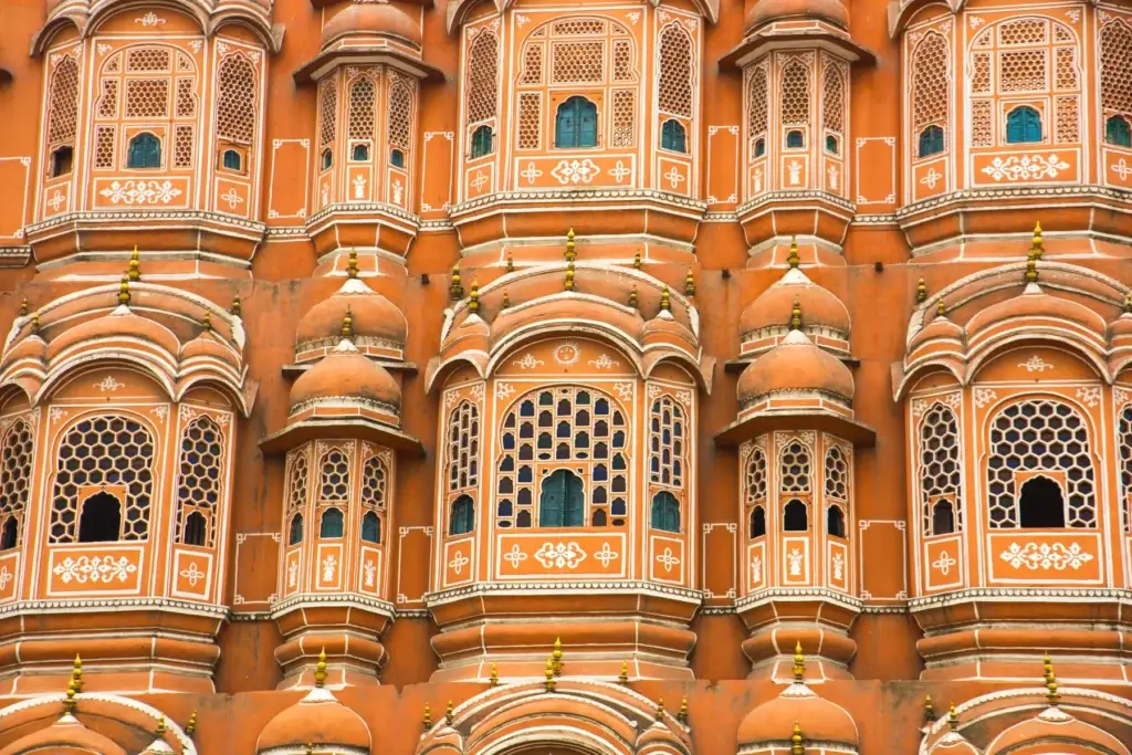 Carved pink sandstone facade of Hawa Mahal in Jaipur