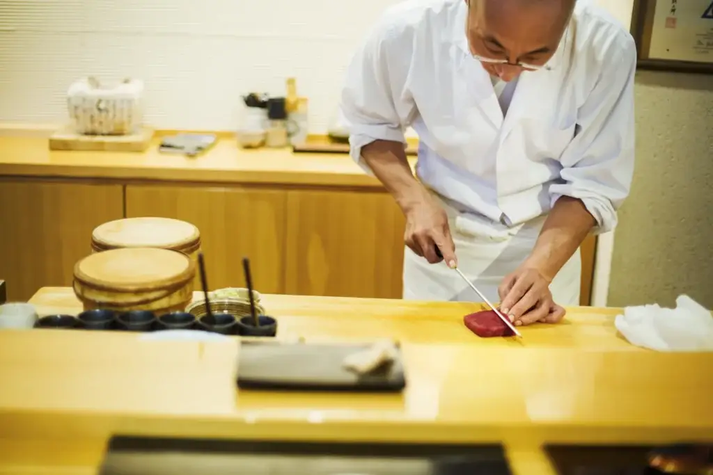 Chef Cutting Fresh Tuna in Japanese Restaurant