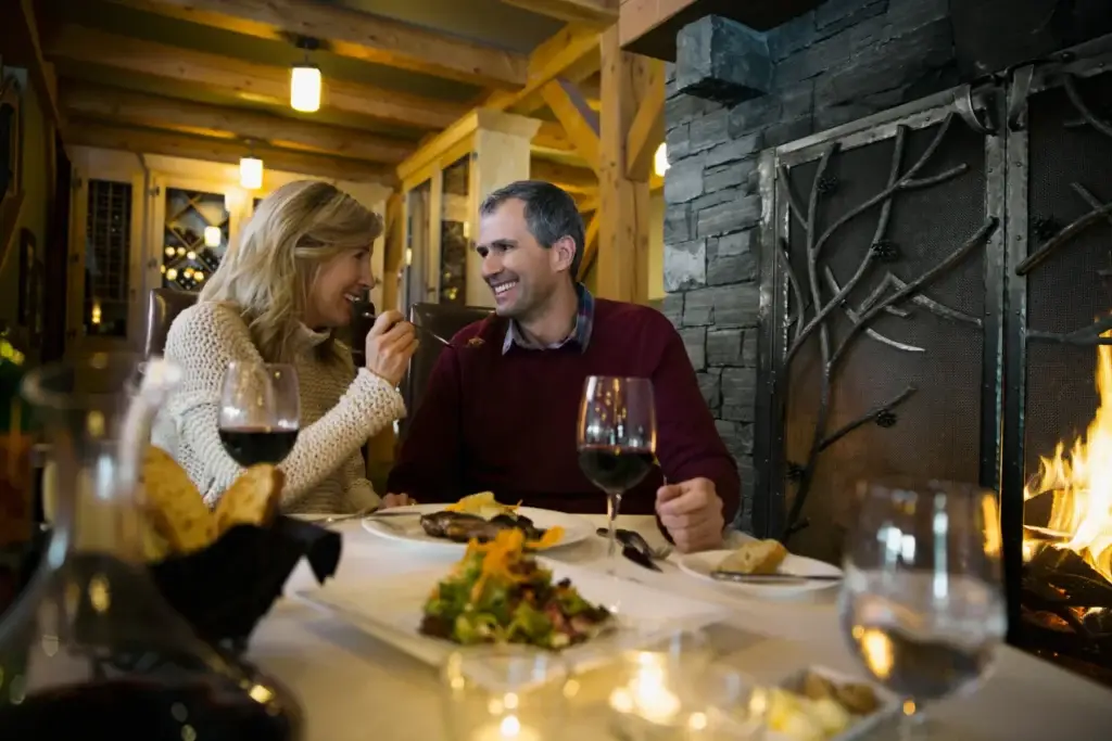 Couple Enjoying Fireside Dinner At Restaurant