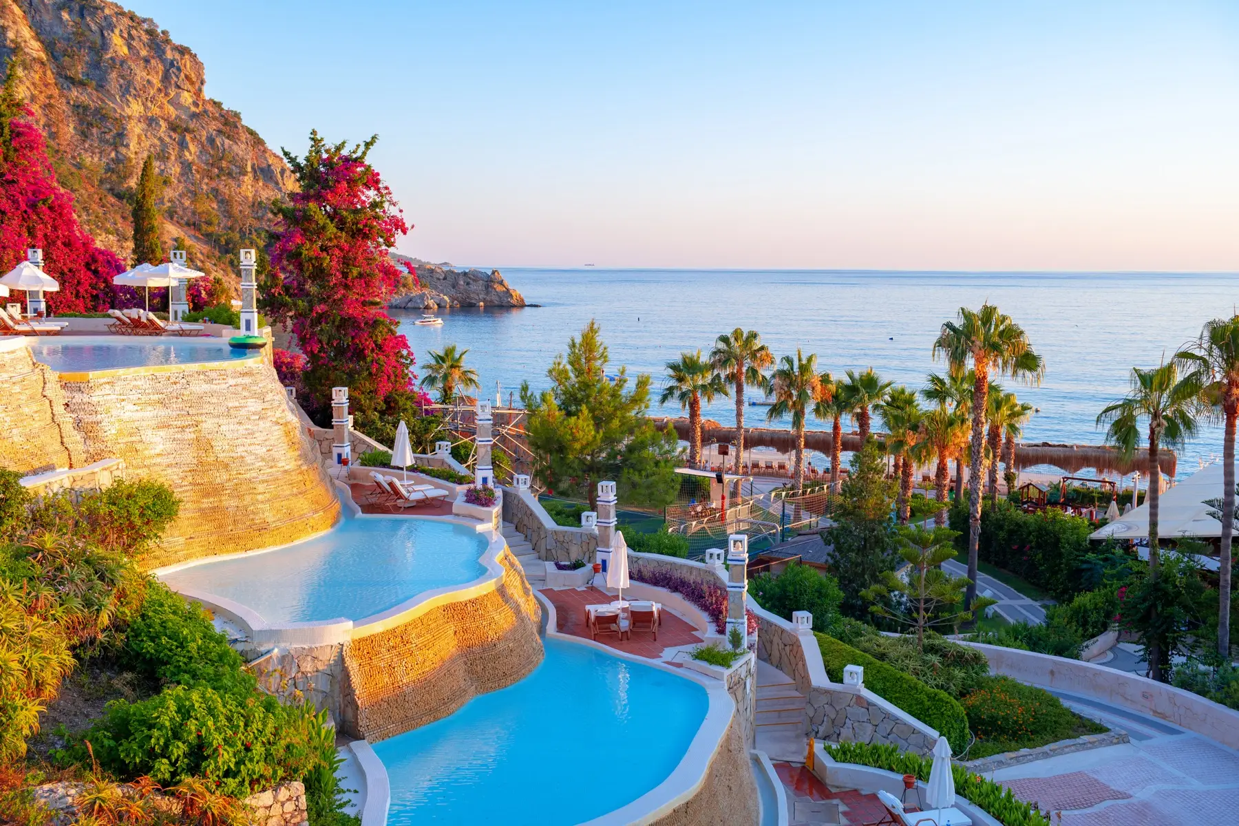 Luxury seaside resort with cascading pools and coastal landscape