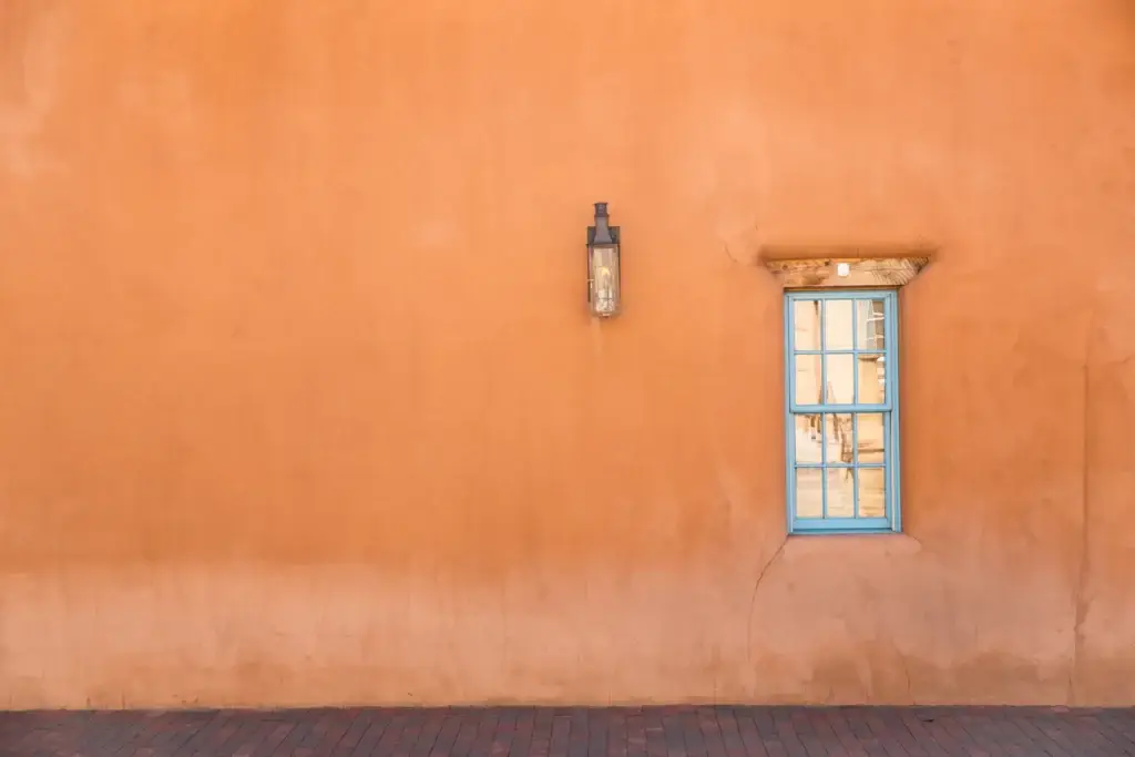 Orange wall with turquoise window in Santa Fe, NM