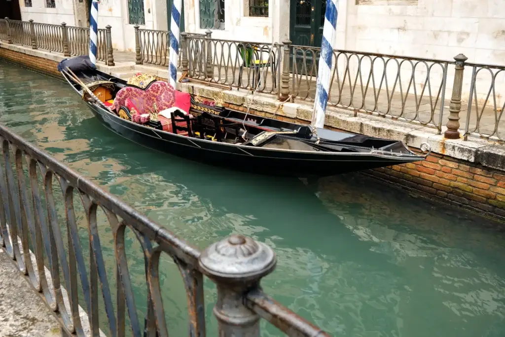 Traditional gondola moored in a narrow Venice canal
