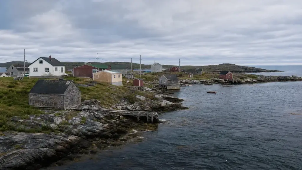 Exact Fogo Island community with vernacular buildings and, if available, a documented contemporary Fogo Island Arts structure in landscape context