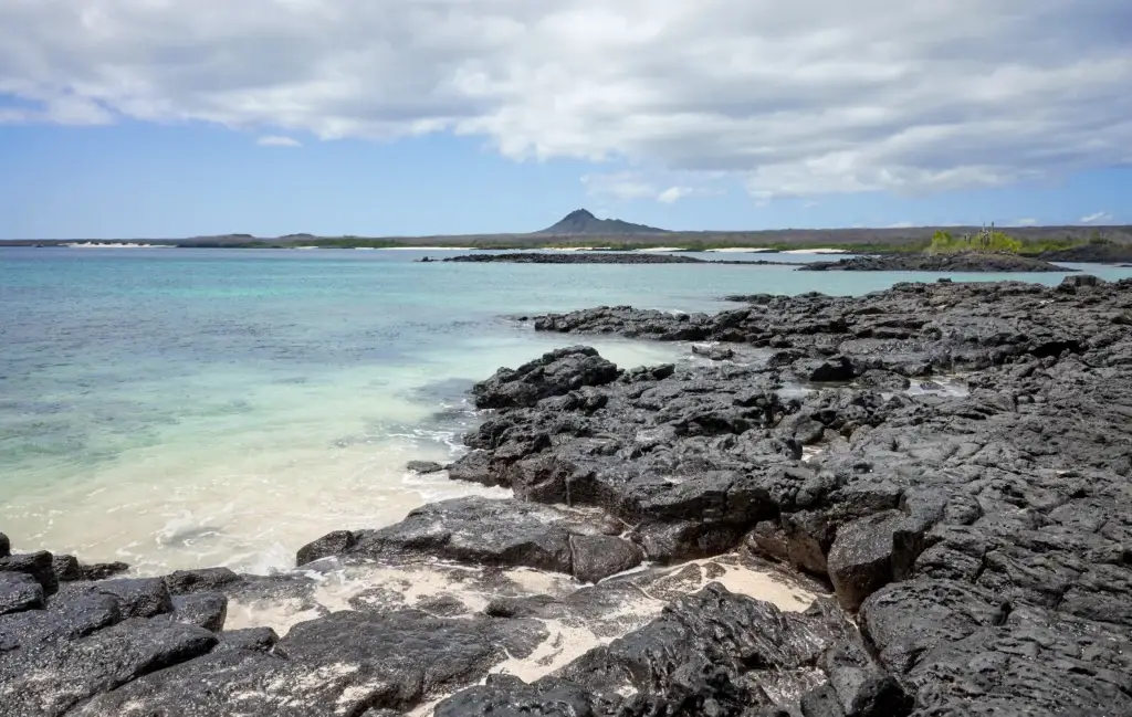 Volcanic rocks on a beach of uninhabited island, Galapagos National Park, Ecuador.