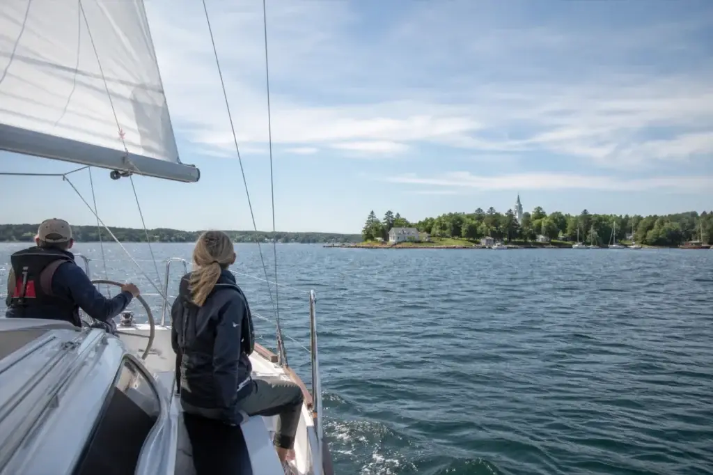 Sailing vessel underway in Chester Harbour with recognizable Chester or Mahone Bay geography