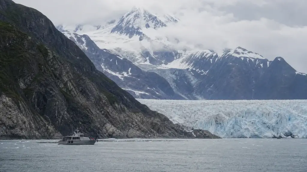 Passenger vessel at respectful distance from a Kenai Fjords tidewater glacier