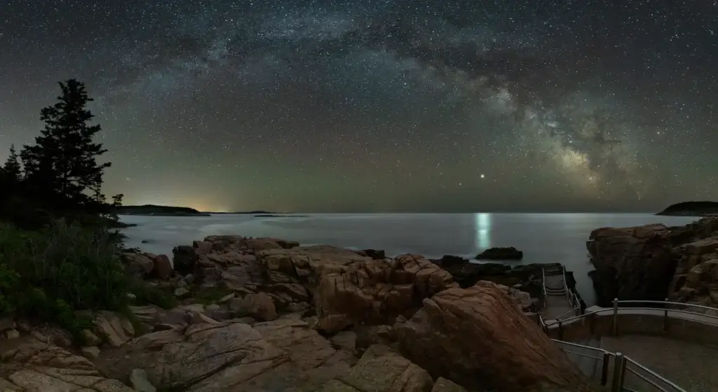 Acadia National Park night sky over a recognizable coastal or mountain landscape