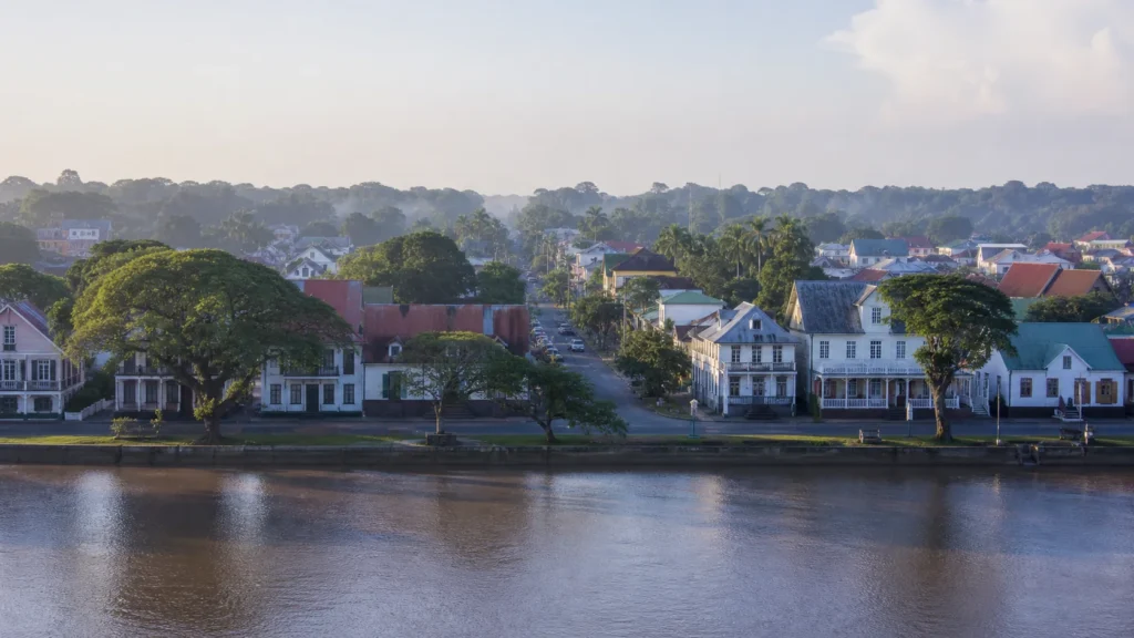 AI-generated editorial visualization of an anonymous Paramaribo and Suriname River city context.
