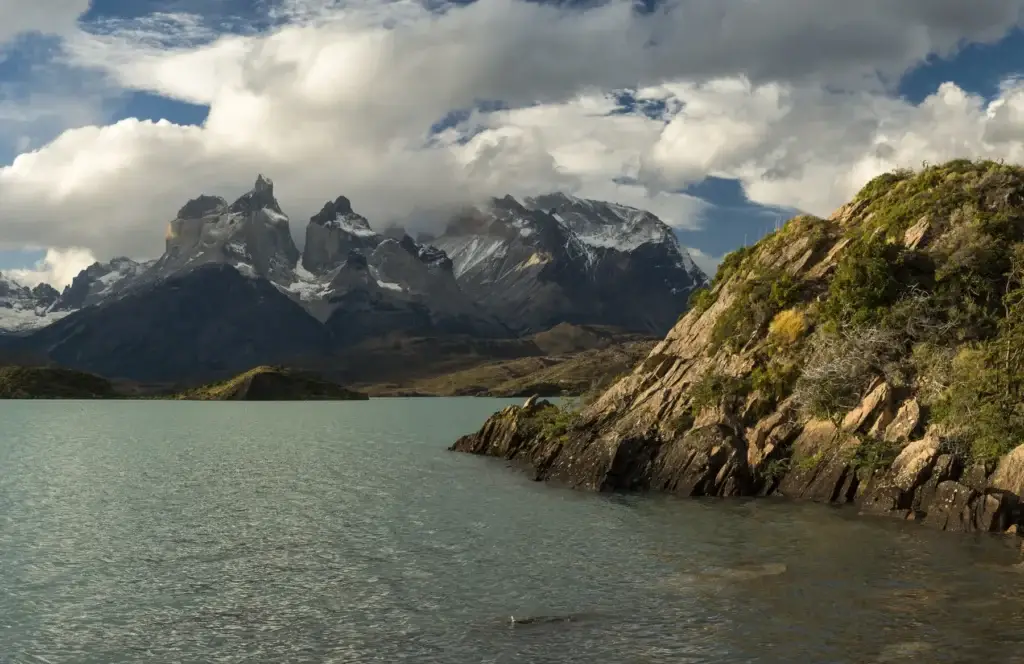 Exact public Torres del Paine landscape at early or late light, without making a hotel the subject