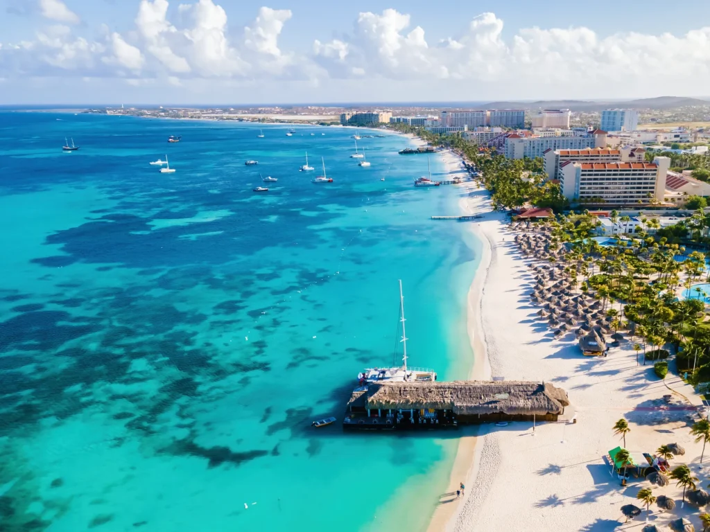 Palm Beach Aruba Caribbean, white long sandy beach with palm trees at Aruba Antilles