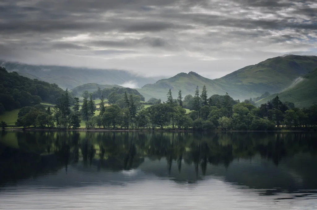 Martindale seen across Ullswater, shown as valley context for a sailing; no particular vessel or operator is depicted.