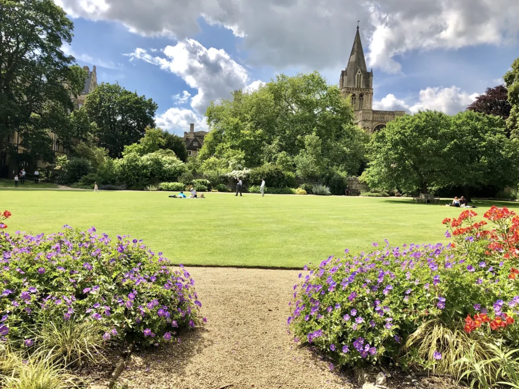 Gardens and cathedral architecture at Oxford University, shown as green city context; not a verified view of Christ Church Meadow.