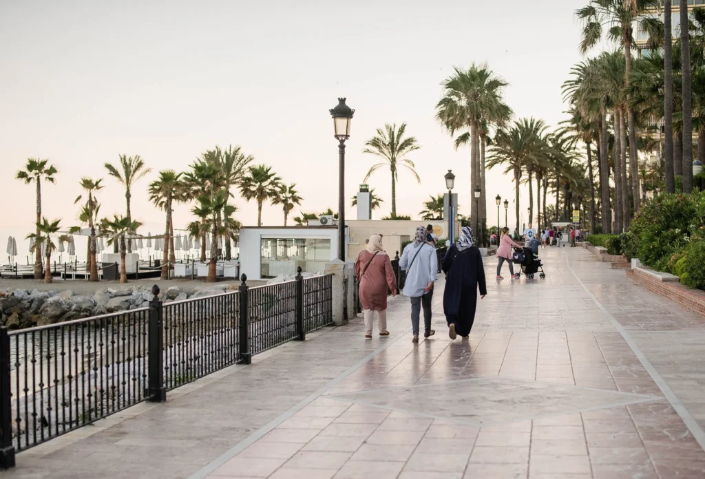 People walking beside the beach in Marbella.