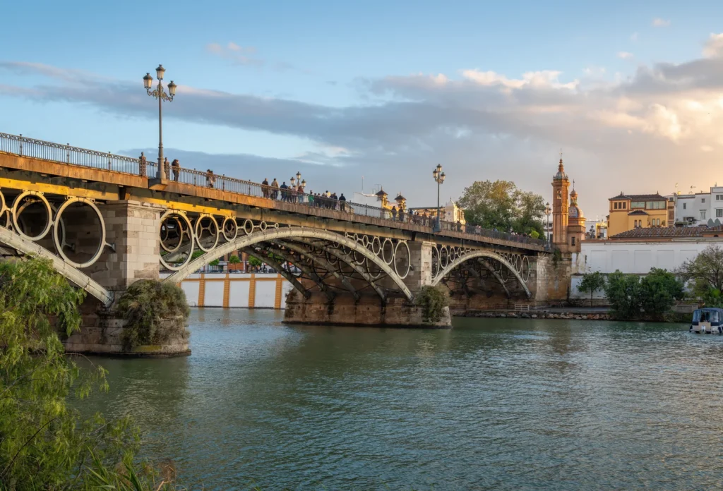 Triana Bridge and Castle of San Jorge beside the Guadalquivir, Seville.