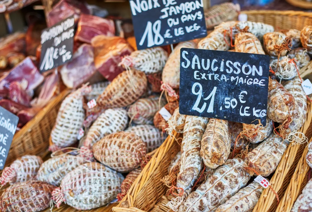 Cured sausages at a French market. Illustrative market context; Dijon’s Halles are not shown.