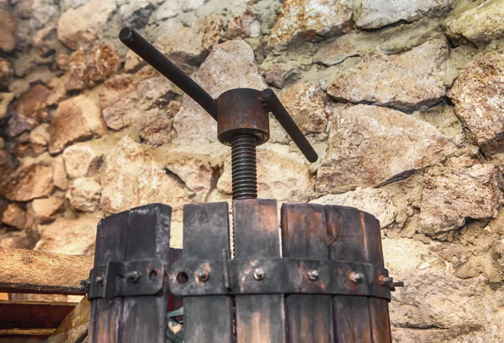 A manual wine press illustrating historic winemaking equipment. This is not verified as Clos de Vougeot.