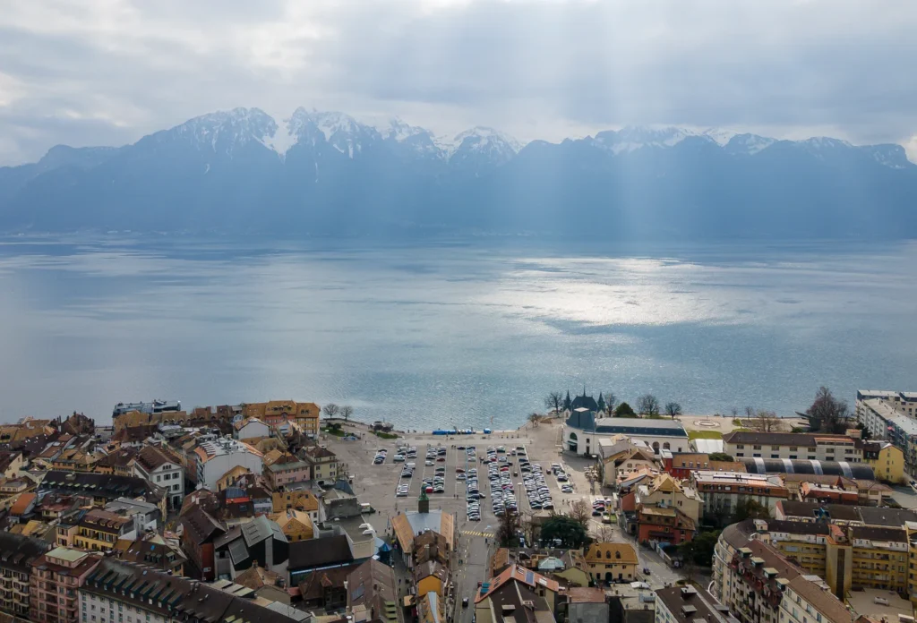 An aerial view of Vevey beside Lake Geneva, providing town context for the waterfront afternoon; the fork sculpture is not identified.