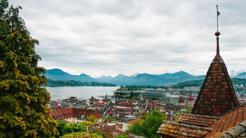 Lucerne city with Lake Lucerne and the Swiss Alps in cloudy conditions.