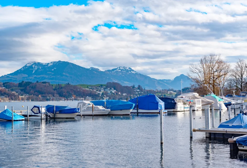 Boats moored on Lake Lucerne, providing lake context. No scheduled cruise is pictured.