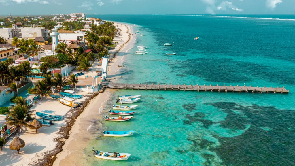 Tropical beach with boats and pier