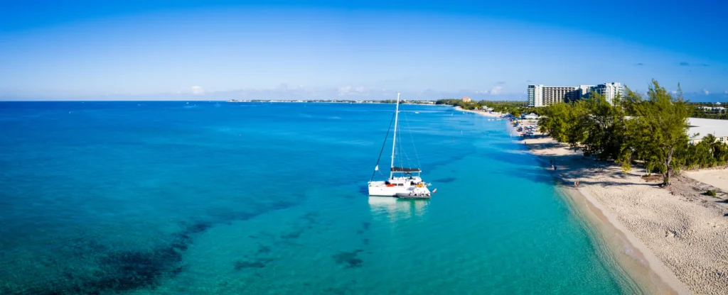 Aerial Drone Image Of Seven Mile Beach, West Bay And George Town On The Island Of Grand Cayman In