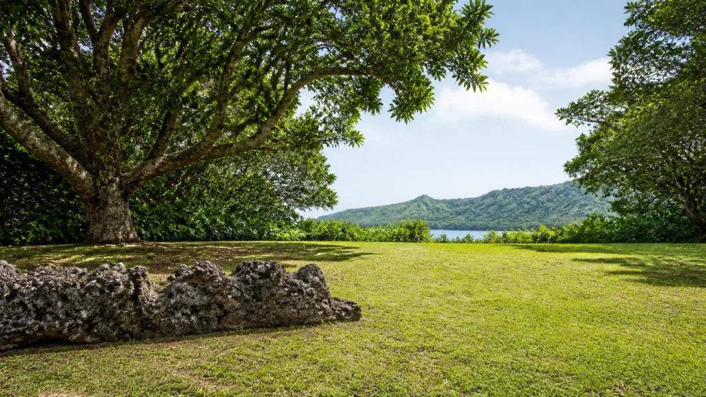 AI-generated editorial visualization of a single non-identifiable weathered basalt platform-edge fragment within a Huahine cultural landscape; not an exact marae plan, named site, current condition, restoration, route, access, cultural permission or archaeological record.