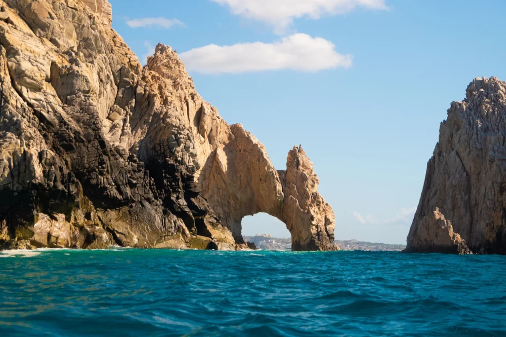 Beautiful shot of the Cabo San Lucas Arch on the Pacific Ocean with blue clean water on a sunny day