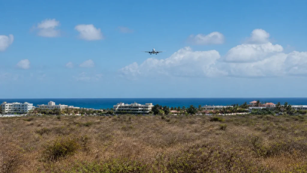 AI-generated editorial visualization of a Maho built-corridor and distant high final-approach relationship from a deliberately anonymous stable inland context; not an exact flight, viewpoint, route, property, access, operation, safety or current-condition record.