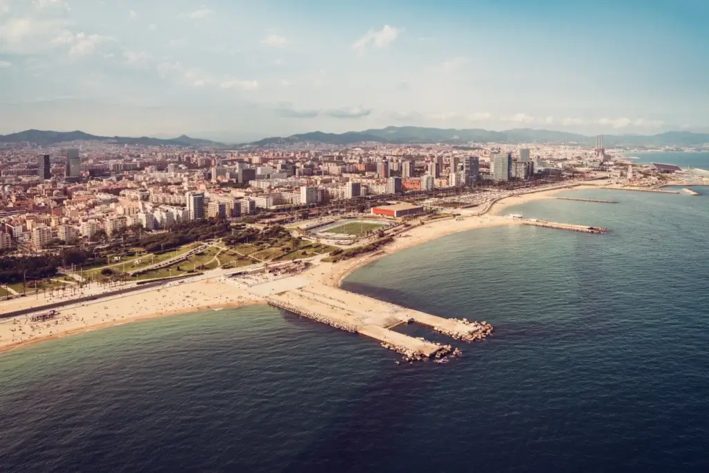 Barcelona aerial city skyline with beach and harbor, Spain
