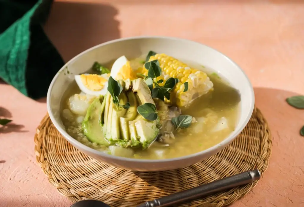 Ajiaco with chicken, corn, potato and avocado.