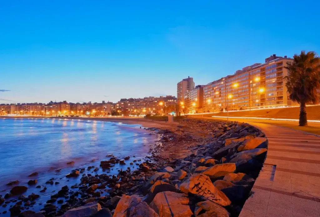 The Rambla beside Playa Pocitos in Montevideo at dusk.